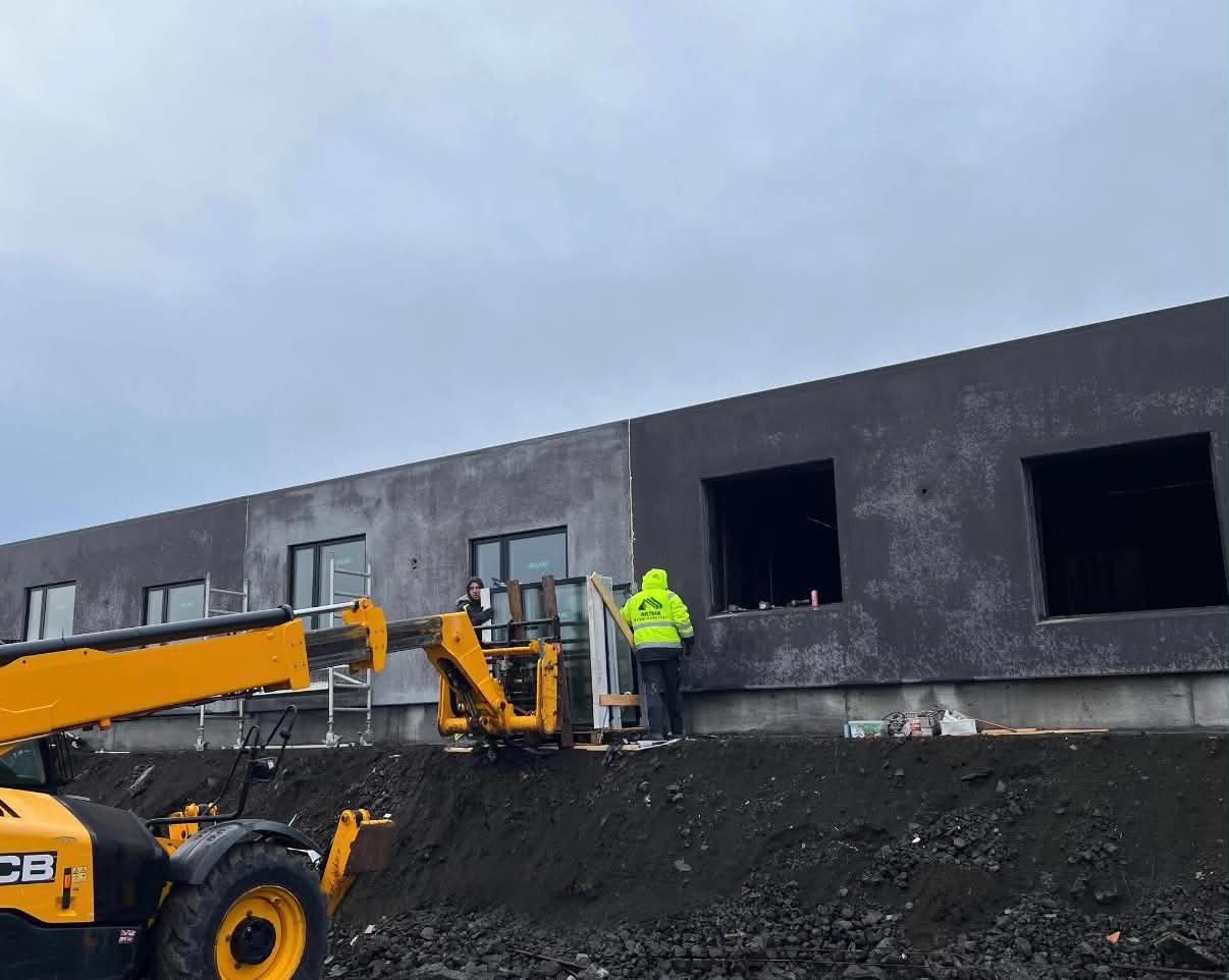 Artma crew installing windows with JCB telehandler